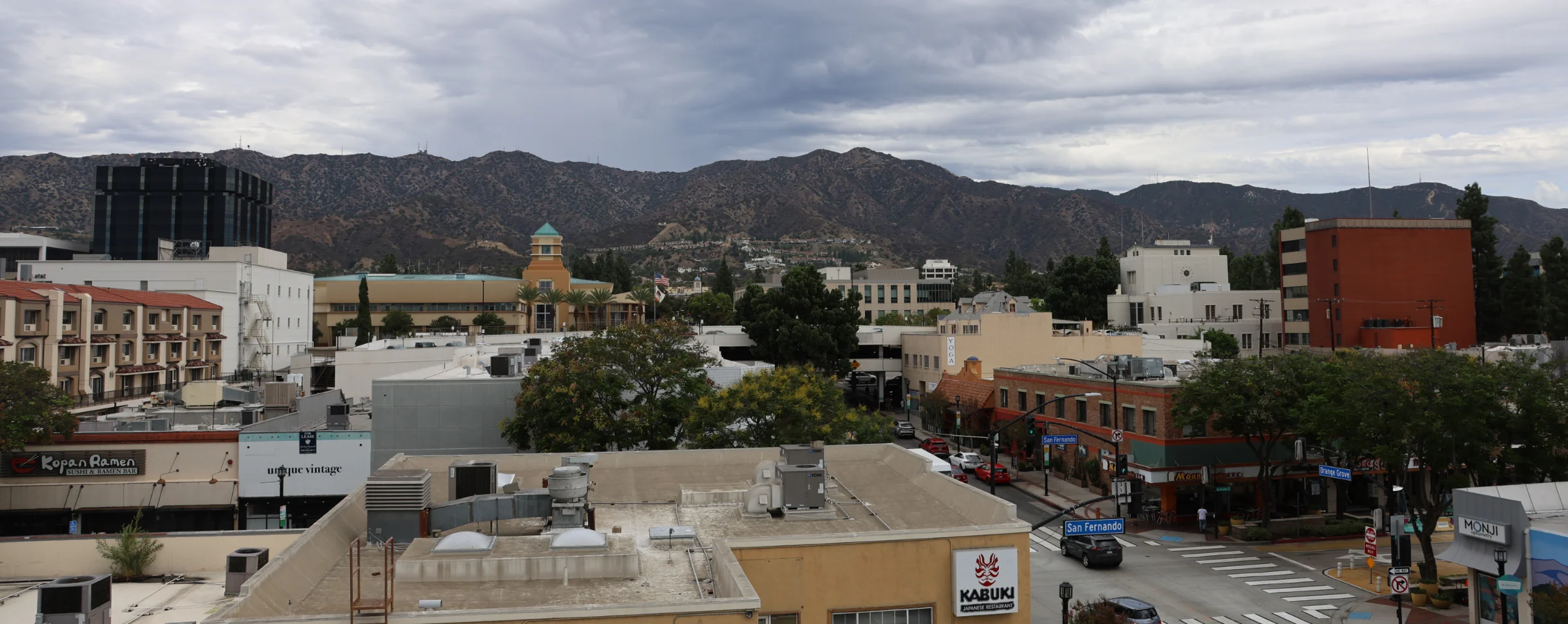 Downtown Burbank rooftops and streets with the hills behind them
